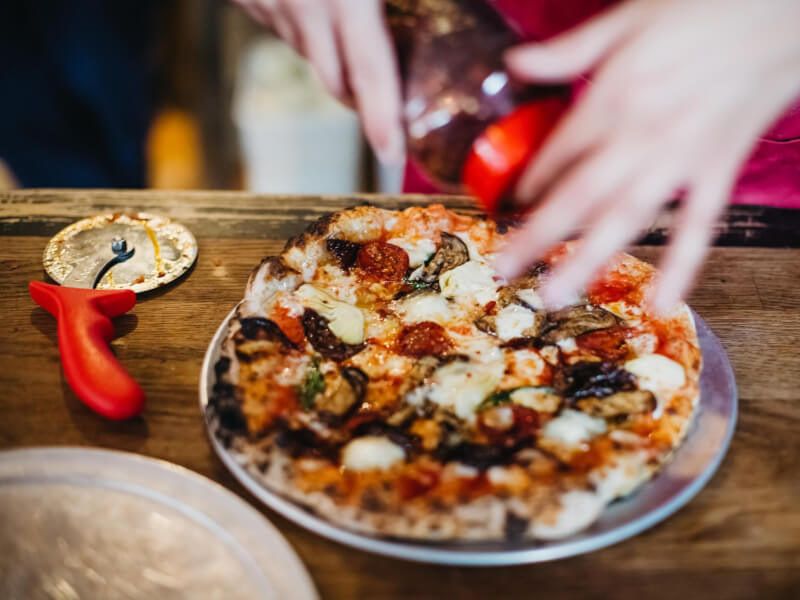 slicing a handmade italian pizza